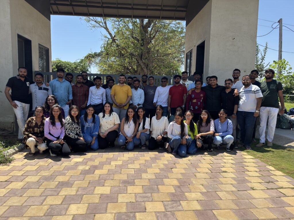 The Flame Solren team together outdoors in front of a gateway