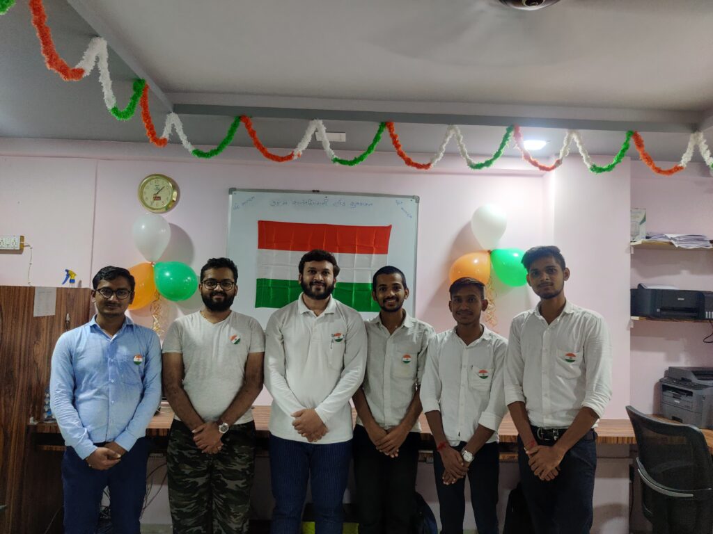 Flame Solren team members in the office, with the Indian flag and tricolour decorations behind them