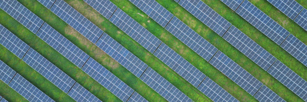 Aerial view of rows of ground-mounted solar modules